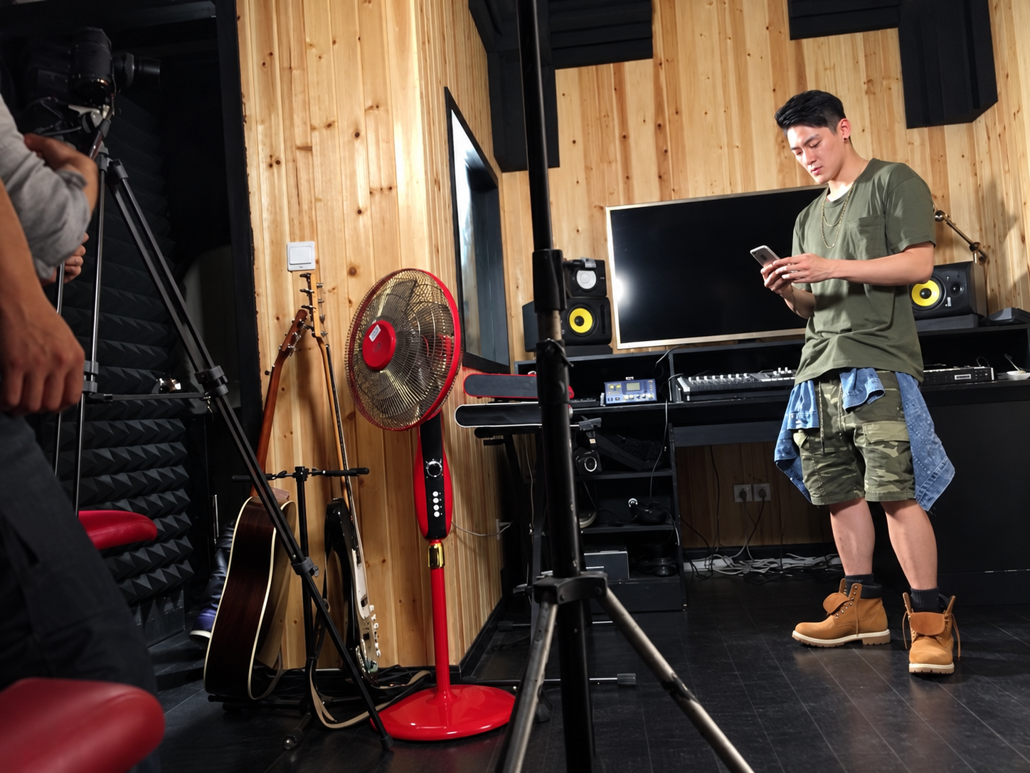 Stanley Yang filming in a recording studio